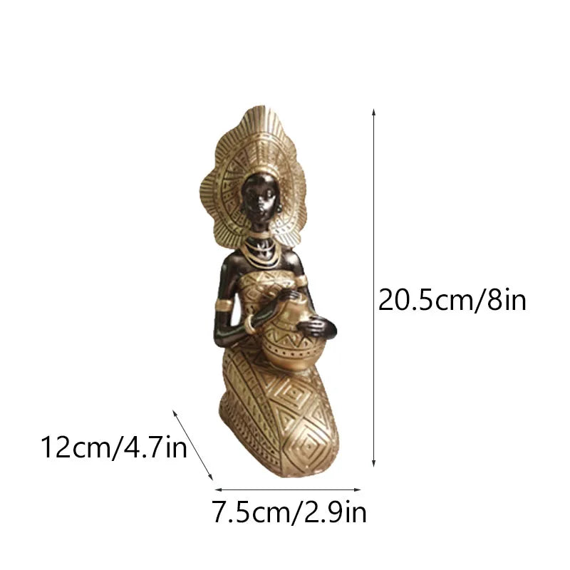 Seated African resin woman statue with gold headdress and patterned dress, 20.5cm tall, holding decorative pot