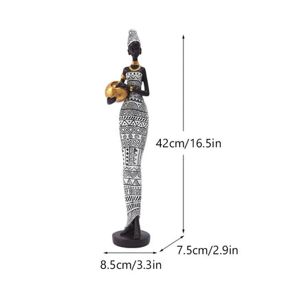 African resin woman statue in black and white tribal dress, 42cm tall, holding a gold pot with 8.5cm base