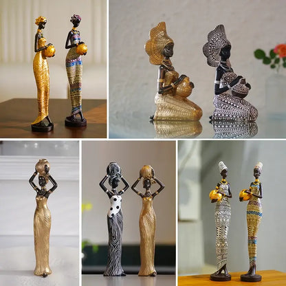 Assorted African resin woman statues in gold, patterned, and tribal dresses, displayed in standing and kneeling poses
