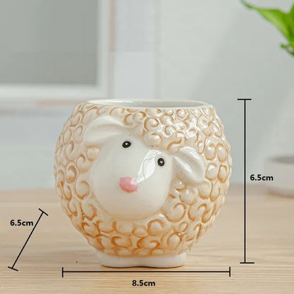 Ceramic sheep-shaped planter holding a green succulent, displayed on a wooden surface.