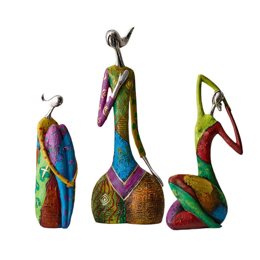 Set of three colorful abstract resin statues with reflective silver-style heads and textured patchwork bodies, displayed in modern art poses

