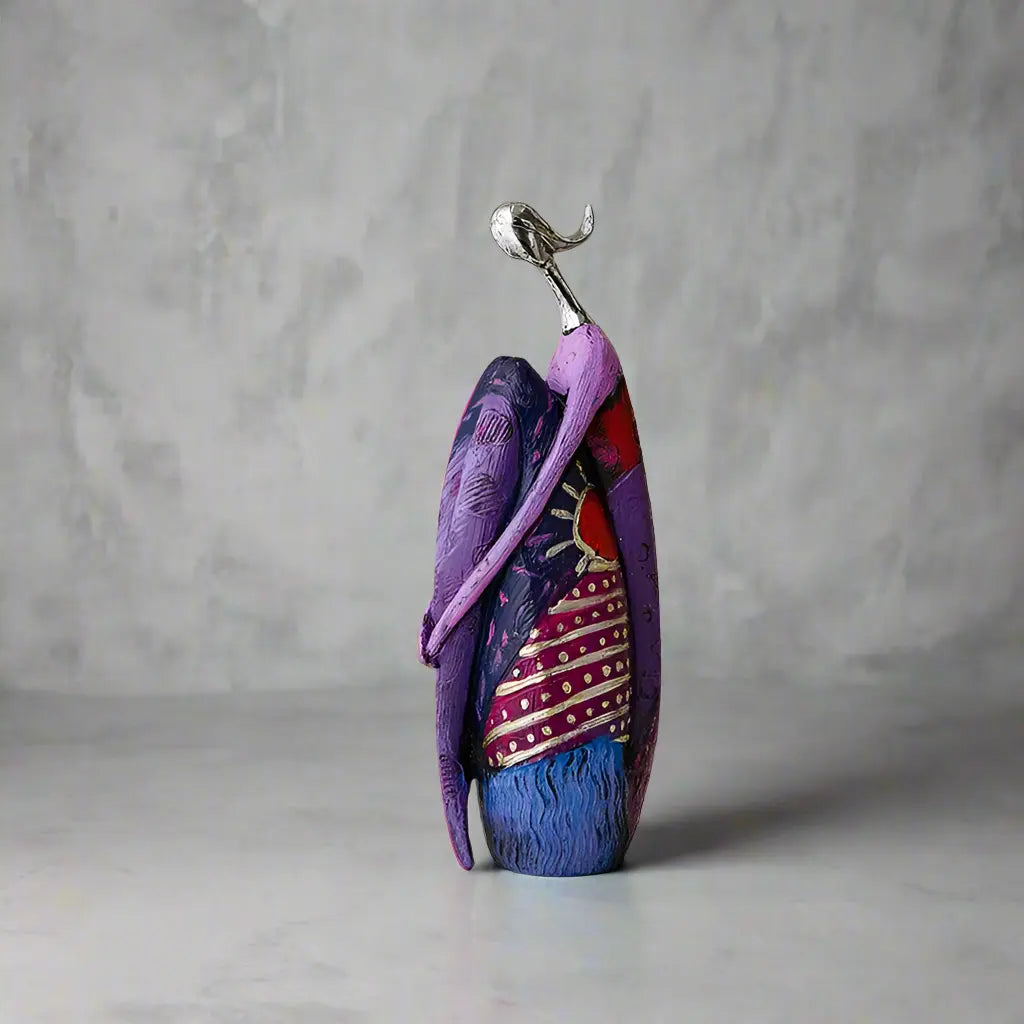 Purple abstract resin statue with silver-look head, sun and star pattern
