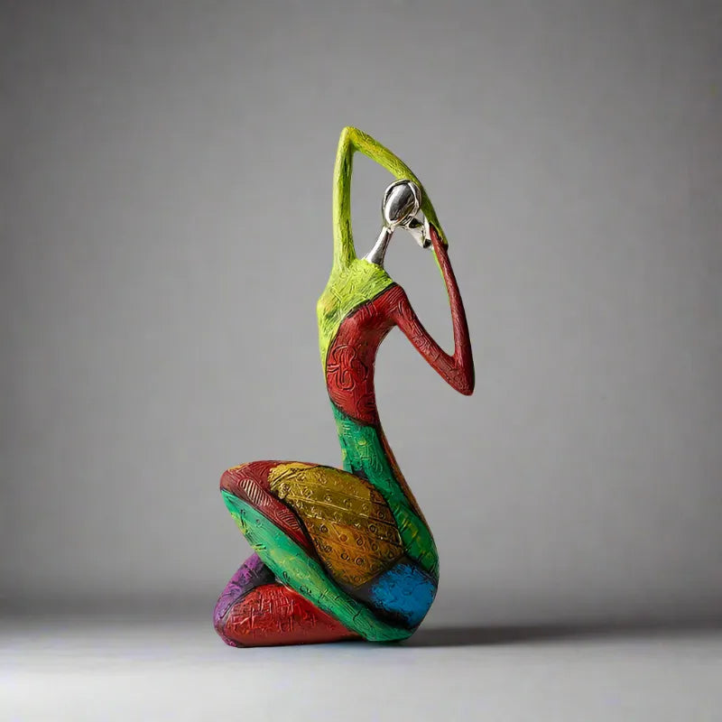 Colorful abstract resin sculpture of a kneeling figure with a polished metallic head and textured patterns in green, red, yellow, and blue – modern artistic home decor ornament