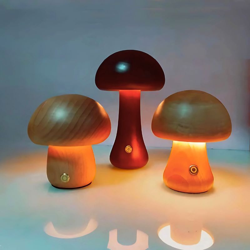 Set of three mushroom-shaped wooden touch lamps lit in warm tones.