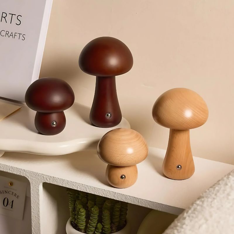 Four wooden mushroom lights styled on a shelf with warm lighting.