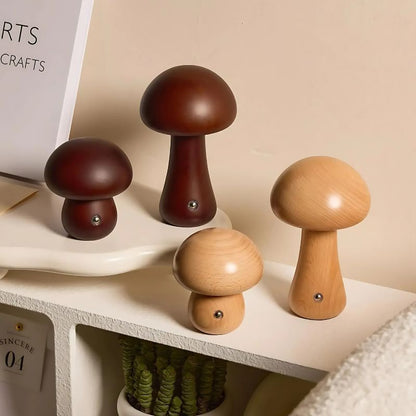 Four wooden mushroom lights styled on a shelf with warm lighting.